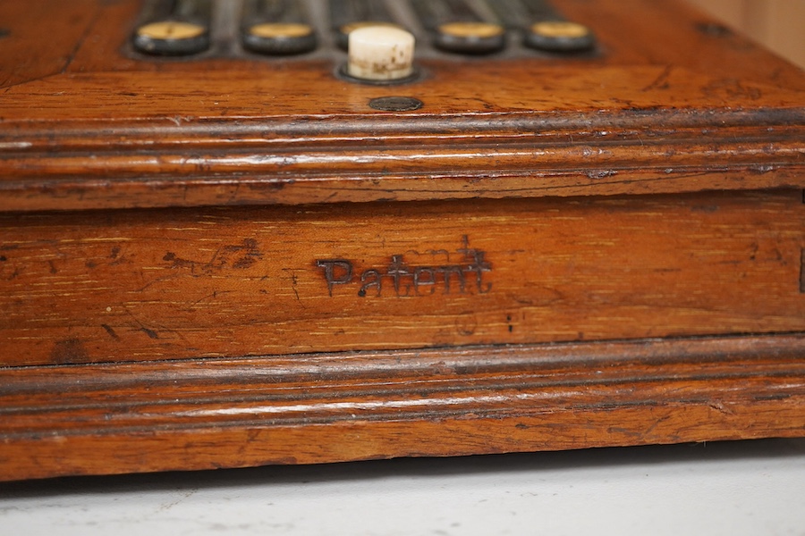 An early 20th century mahogany cased telephone, possibly by Ericsson, with handset on decorative cradle and five switchboard selector levers, stamped ‘Patent’ to front of the case, and with paper label underneath reading